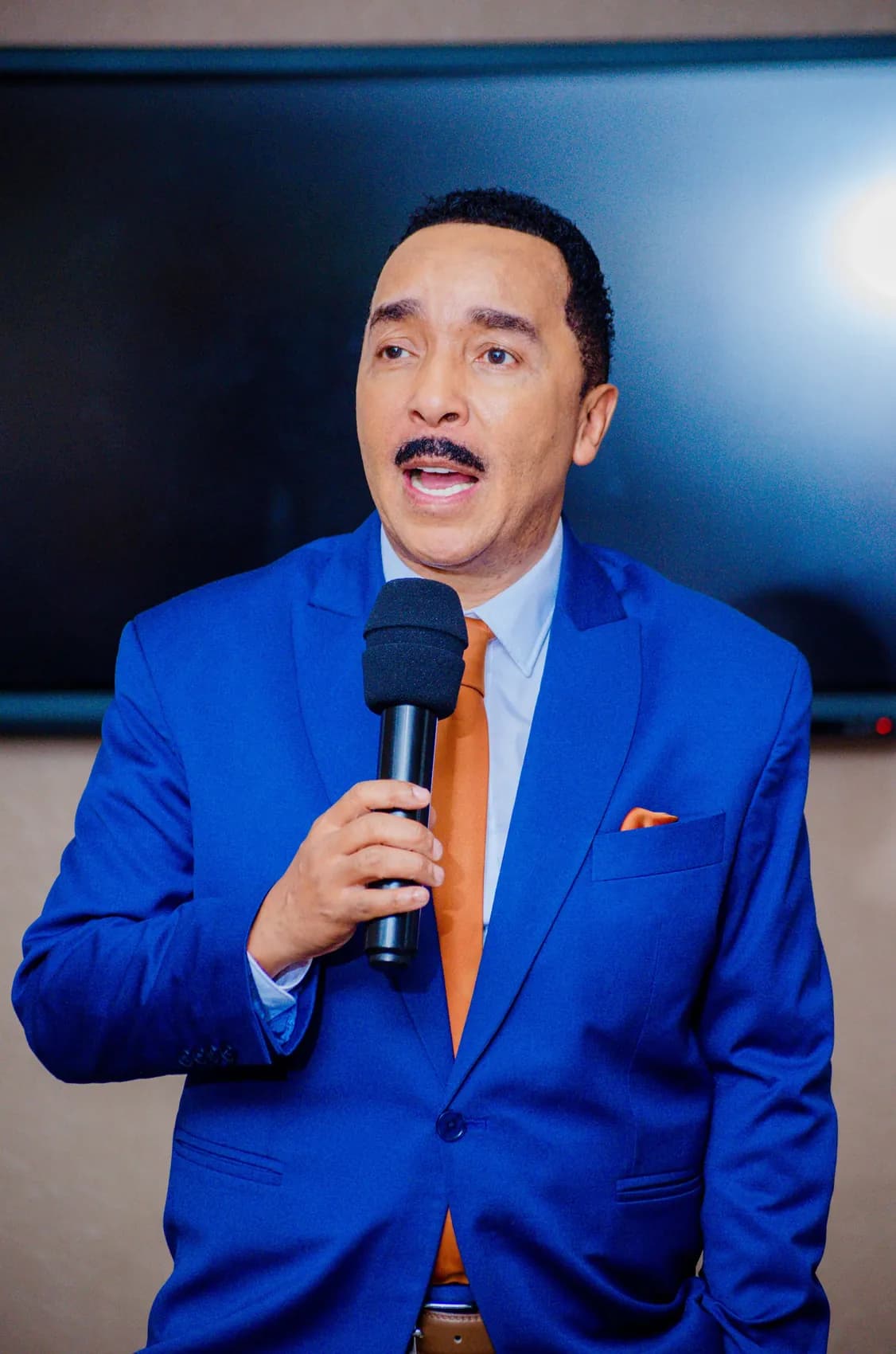 Dr David Molapo speaking in a blue suit.