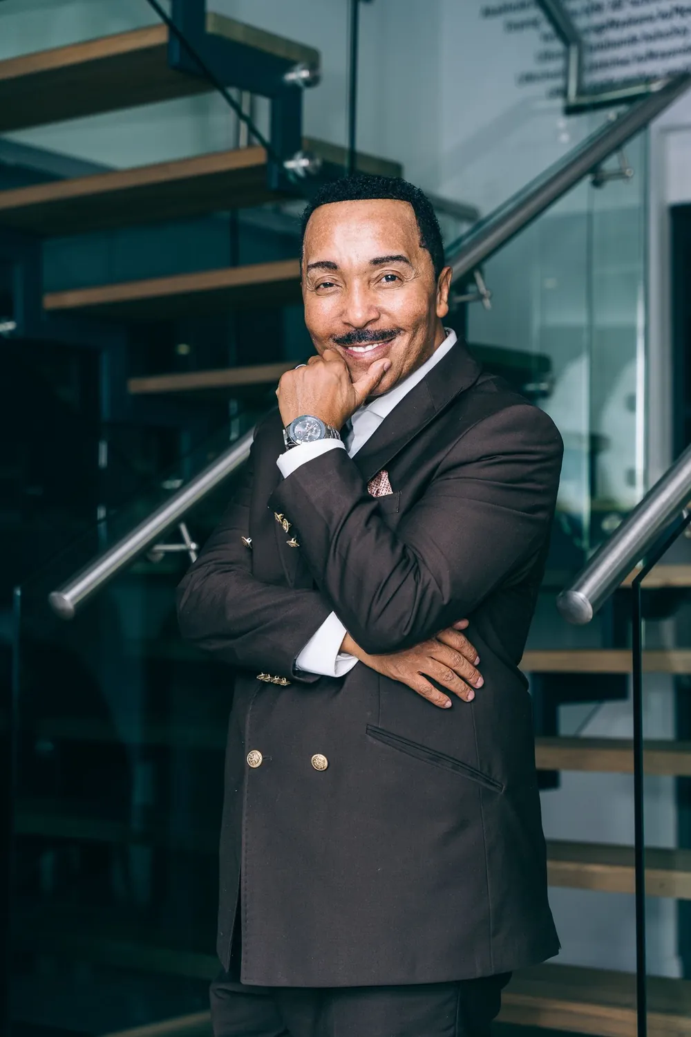 Dr David Molapo, arms folded, smiling in a studio.